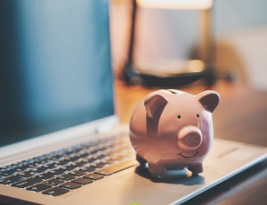 A piggy bank on a laptop computer