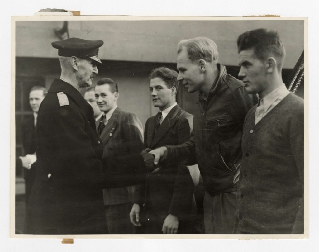 King Haakon VII of Norway shaking hands with crew members of a Norwegian merchant ship (Nortraship) in Newcastle.